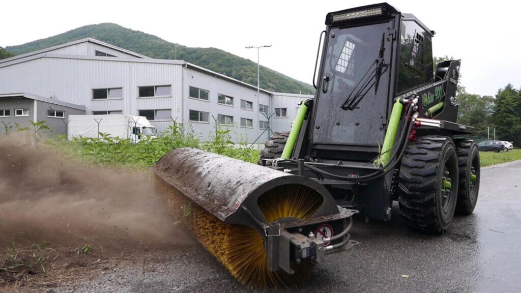 Kovaco angle brush sweeping a yard