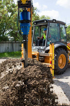 Auger Torque 7000 MAX earth drill on a backhoe loader
