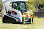 Skid steer pallet forks lifting a pallet