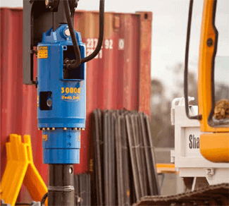Auger Torque earth drill drilling a hole with an excavator