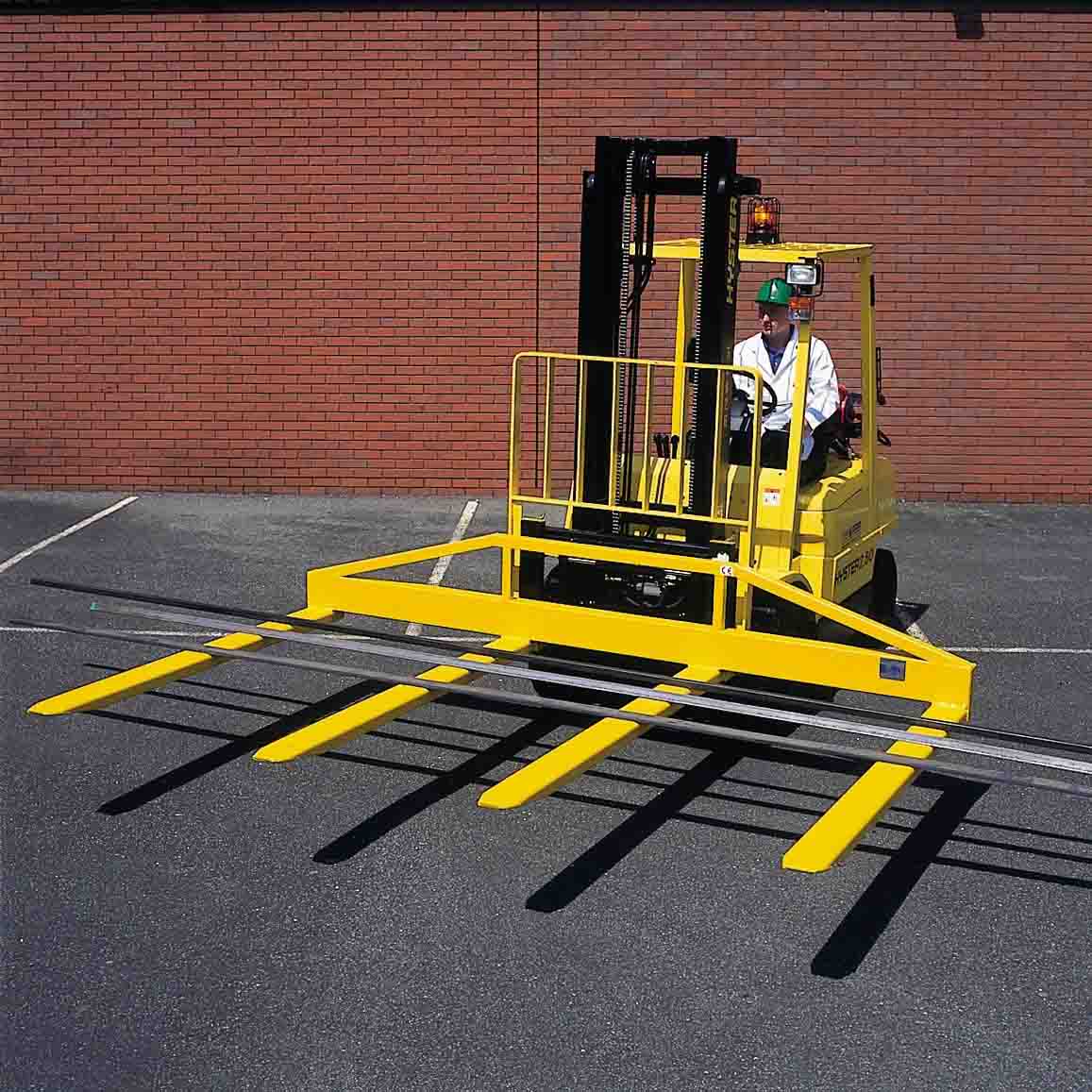 Four fork attachment fitted to a forklift, with two outer forks on a cross beam